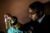 U.S. Surgeon General Vivek Murthy inspects a plastic bottle filled with murky tap water in a Flint, Michigan home.