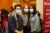 Three masked students pose for the camera in Kresge during orientation.